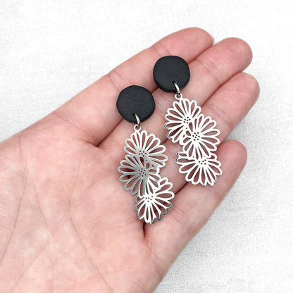 Black polymer clay with flower charms. Handmade earrings.