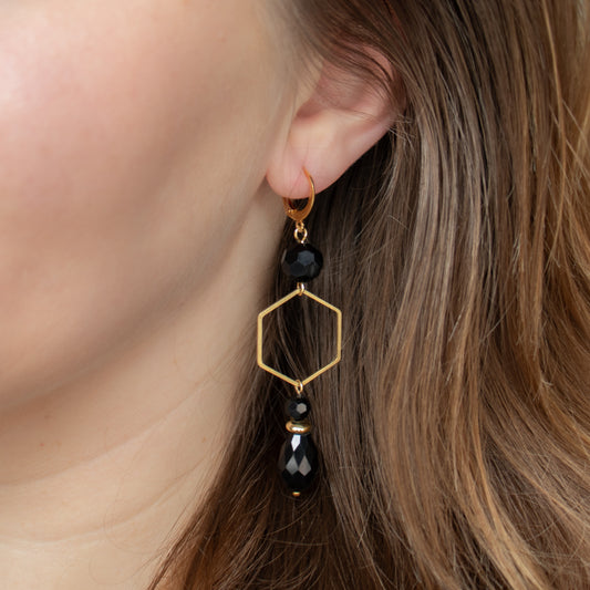 Black beads with gold charms. Handmade long earrings.