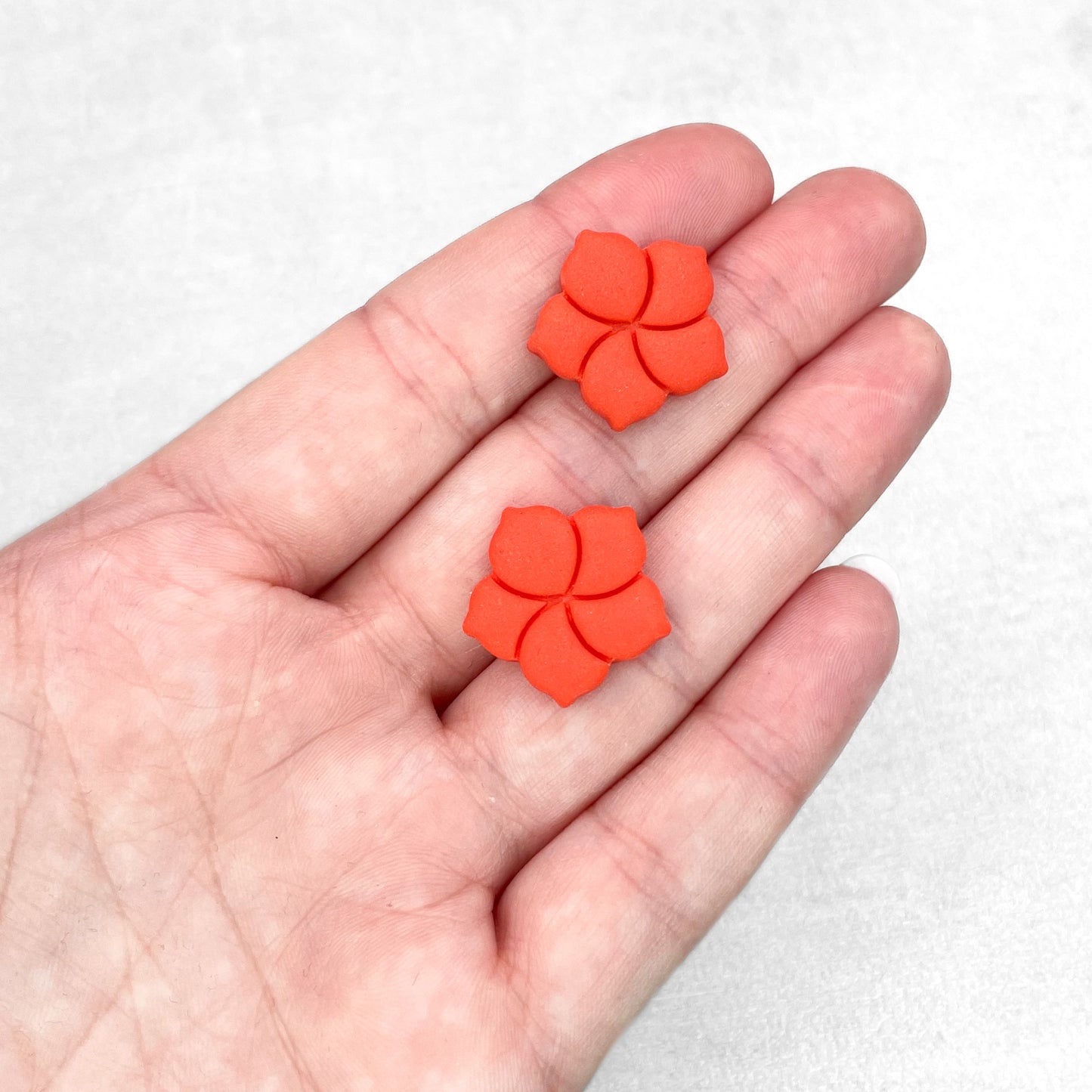 Orange red flower stud earrings. Handmade polymer clay stud earrings.